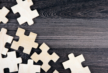 puzzle elements on a wooden background as a riddle