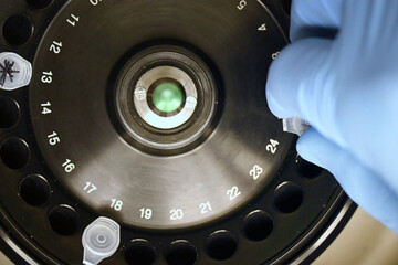 Close-up of unfocused laboratory centrifuge with tubes