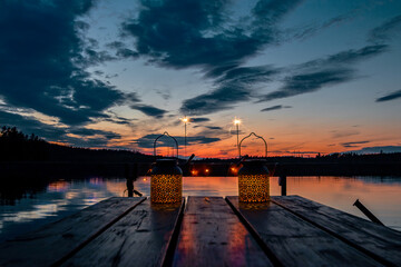 Romantic evening near a swedish lake with candle light and sunset