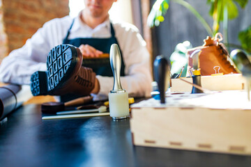 skilled shoemaker make a leather shoes in workshop