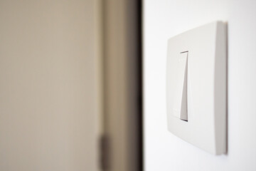 white lighting switch on concrete wall