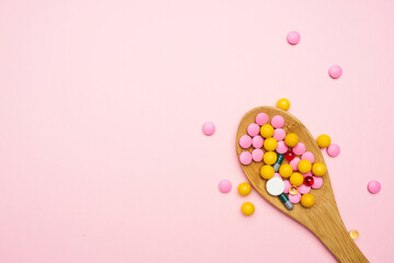 Fototapeta na wymiar spoon with colorful pills top view medicine health care