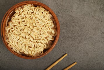 Ready-to-eat instant noodles in a wooden cup