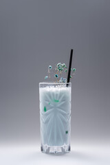 milk drink or cocktail blue hawaii decorated in glass on grey background