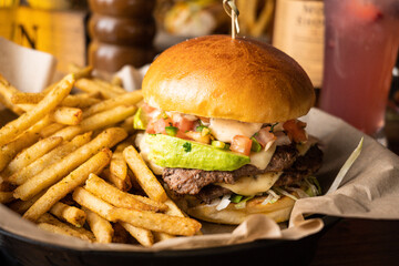 Burger with avocado and fries