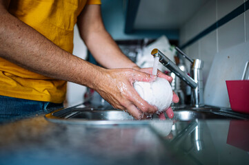 Man washing dishes in the sink