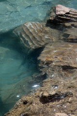 Ruins of ancient column and construction blocks of antique city Hierapolis, in Pamukkale, Turkey under water.