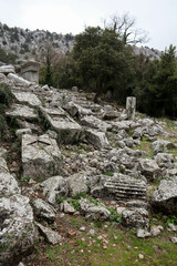 stone and marble debris in grass, ancient city Termessos in Turkey