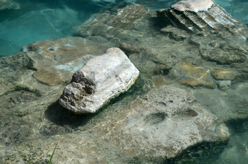 Ruins of ancient column and construction blocks of antique city Hierapolis, in Pamukkale, Turkey under water.