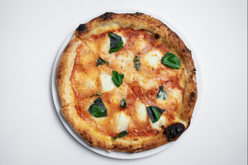 top view of margarita pizza with tomatoes, cheese and basil on white background
