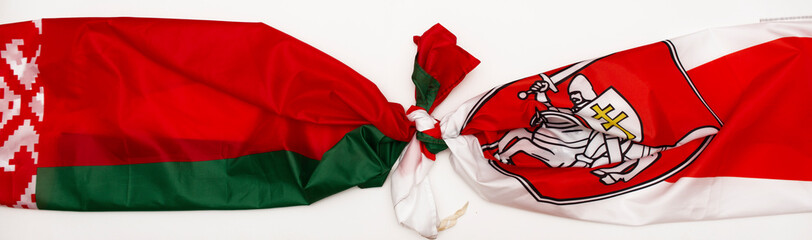 Two flags of Belarus Red-green flag of Belarus with a White-red-white flag tied together in a knot