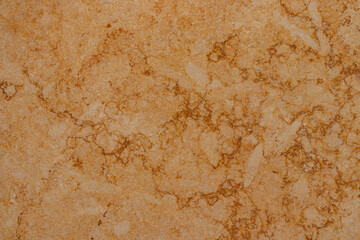 Golden marble surface with dark veining in random pattern