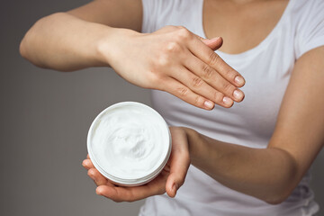 woman with cream in hands cosmetics hand skin care closeup