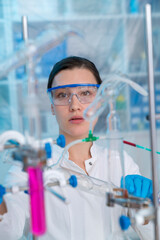 Young woman in a pharmacological laboratory. Development of an antiviral drug. Pandemic COVID-19