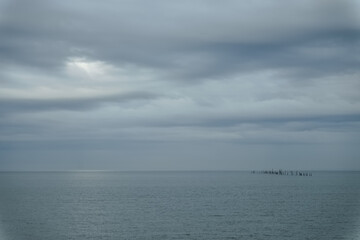 The Chesapeake Bay entrance on a cloudy day with the Bay-Tunnel bridge off in the distance