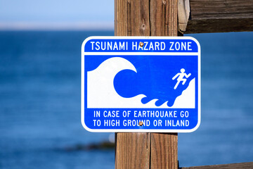Tsunami Hazard Zone warning sign on ocean coast warn the public about possible danger after an...