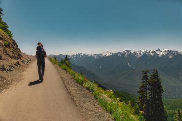 Father carrying young son on shoulders as they hike Hurricane Hill in Olympic National Park