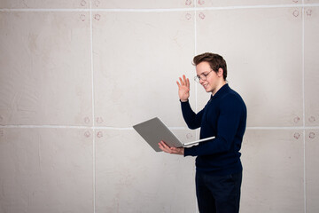 Young student at an online conference. A man with a laptop in his hands on a white background.