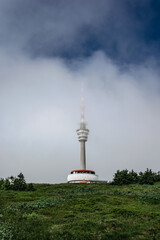 Fototapeta premium Television transmitter tower with observation platform on foggy peak of Praded,Jeseniky mountains,Czech republic.Views of picturesque countryside,popular tourist place for hiking and leisure.Misty day