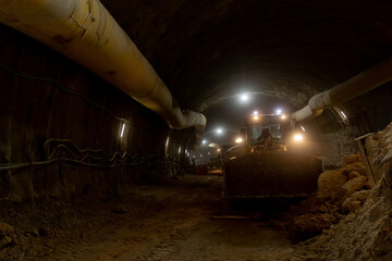 A tractor and underground tunnel construction
