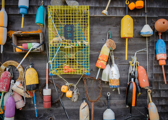 Old collected Lobster Pot floats hanging on a wooden Lobster shack