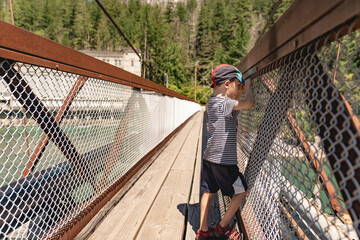 Boy looking at the Skagit River on a suspension bridge in North Cascades National Park