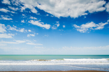 beach with cloudy blue sky