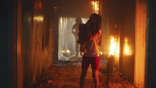 Firefighters helping scared girl in fire