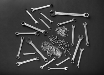 Metal nuts and bolts close up on black background