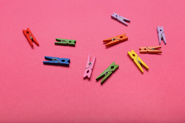Clothespins on pink background