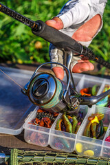 A large fisherman's tackle box fully stocked with lures and gear for fishing.fishing lures and accessories in the box background.