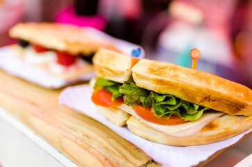 close up of a waffle sandwich with lettuce and tomato