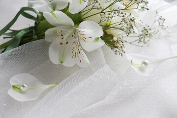 Fototapeta na wymiar wedding card design. bouquet of white flowers on a white background and wedding rings 