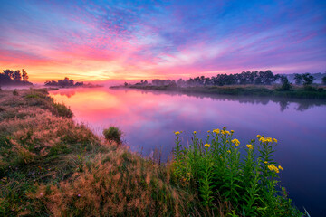 Fototapeta na wymiar Colorful sunrise over the river banks