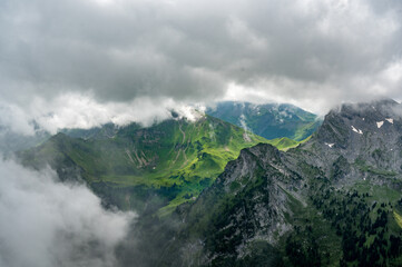 Obraz na płótnie Canvas epic view through mist from Seehorn over Diemtigtal in the Bernese Alps