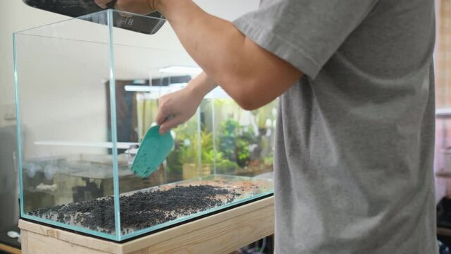 Set up Aquarium tank at home with next step of lava stone or sand and sometime use aquatic soil to bottom of the fresh water tank.
