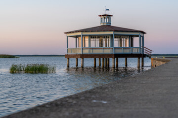 Estonia, Haapsala. The concrete edge of the seafront promenade and a wooden pavilion located above the water