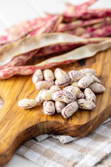 Cranberry beans. Beans pods on cutting board.