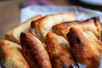 Homemade cake from the oven is cut into triangles and laid in a dish.