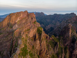 Aerial view of picturesque volcanic mountains at sunrise.
