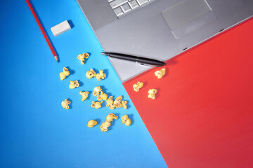 Top view macbook laptop with popcorn ready for studying