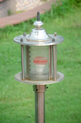 Electric glass lamp with red bulb in the garden.