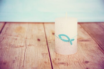 Candle with fish as a symbol for confirmation, communion, baptism - greeting card or invitation