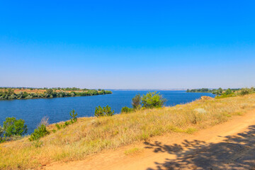 Summer landscape with beautiful river, green trees and blue sky
