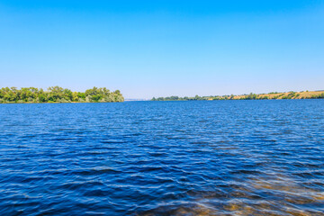 Summer landscape with beautiful river, green trees and blue sky