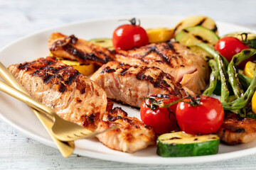 grilled salmon and vegetables on a plate