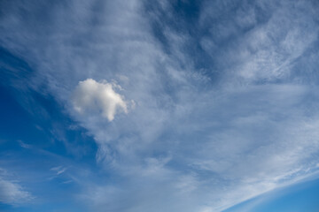 Detailed image of white clouds in a colorful blue sky.
