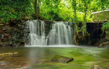 Stream flowing over a historic weir