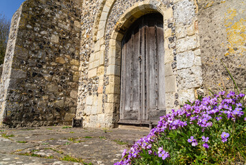 Fototapeta na wymiar Historic church door and flowers