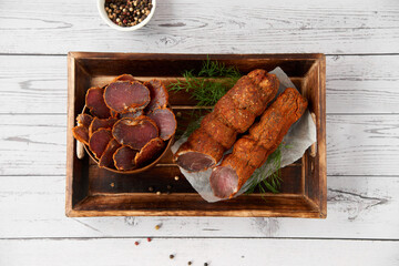 Homemade jerked dried meat or biltong with spices on a wooden background. Beer snack concept....